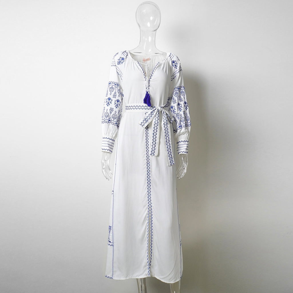 Bahia Maxi Dress White With Blue Embroidery Long Puffed Peasant Sleeves Embroidered Pockets Bohemian Tassel Ties Available In Small Medium Large Or XL Bahia Maxi Dress White With Blue Embroidery Long Puffed Peasant Sleeves Embroidered Pockets Bohemian Tassel Ties Available In Small Medium Large Or XL