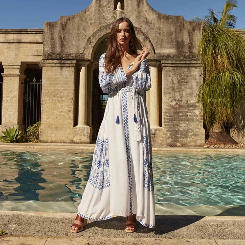Bahia Maxi Dress White With Blue Embroidery Long Puffed Peasant Sleeves Embroidered Pockets Bohemian Tassel Ties Available In Small Medium Large Or XL Bahia Maxi Dress White With Blue Embroidery Long Puffed Peasant Sleeves Embroidered Pockets Bohemian Tassel Ties Available In Small Medium Large Or XL